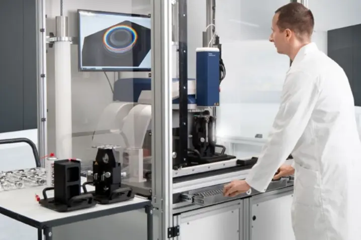 Technician operating a Polytec 3D optical profilometer for high-precision, non-contact surface metrology and texture analysis.