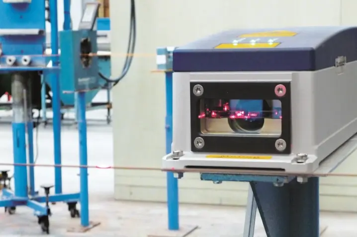 Polytec LSV laser surface velocimeter measuring precision length and speed of wire in industrial manufacturing environment.