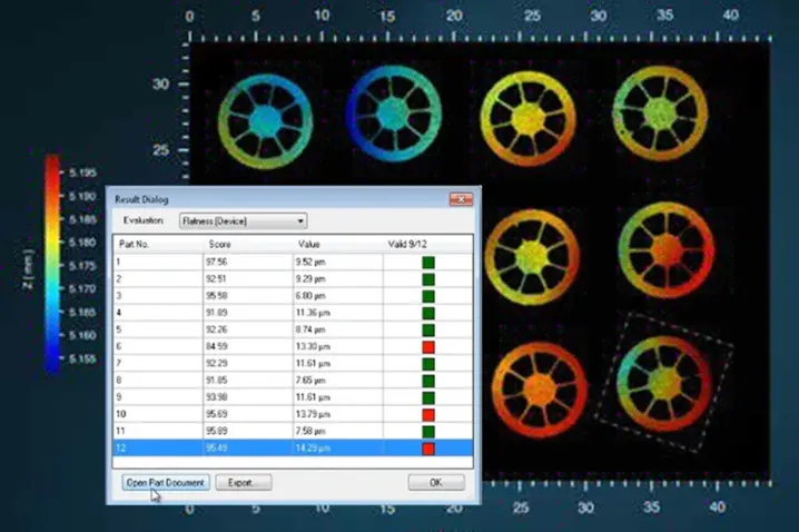 Color-coded flatness analysis of industrial parts with a results dialog showing pass/fail scores and measurements